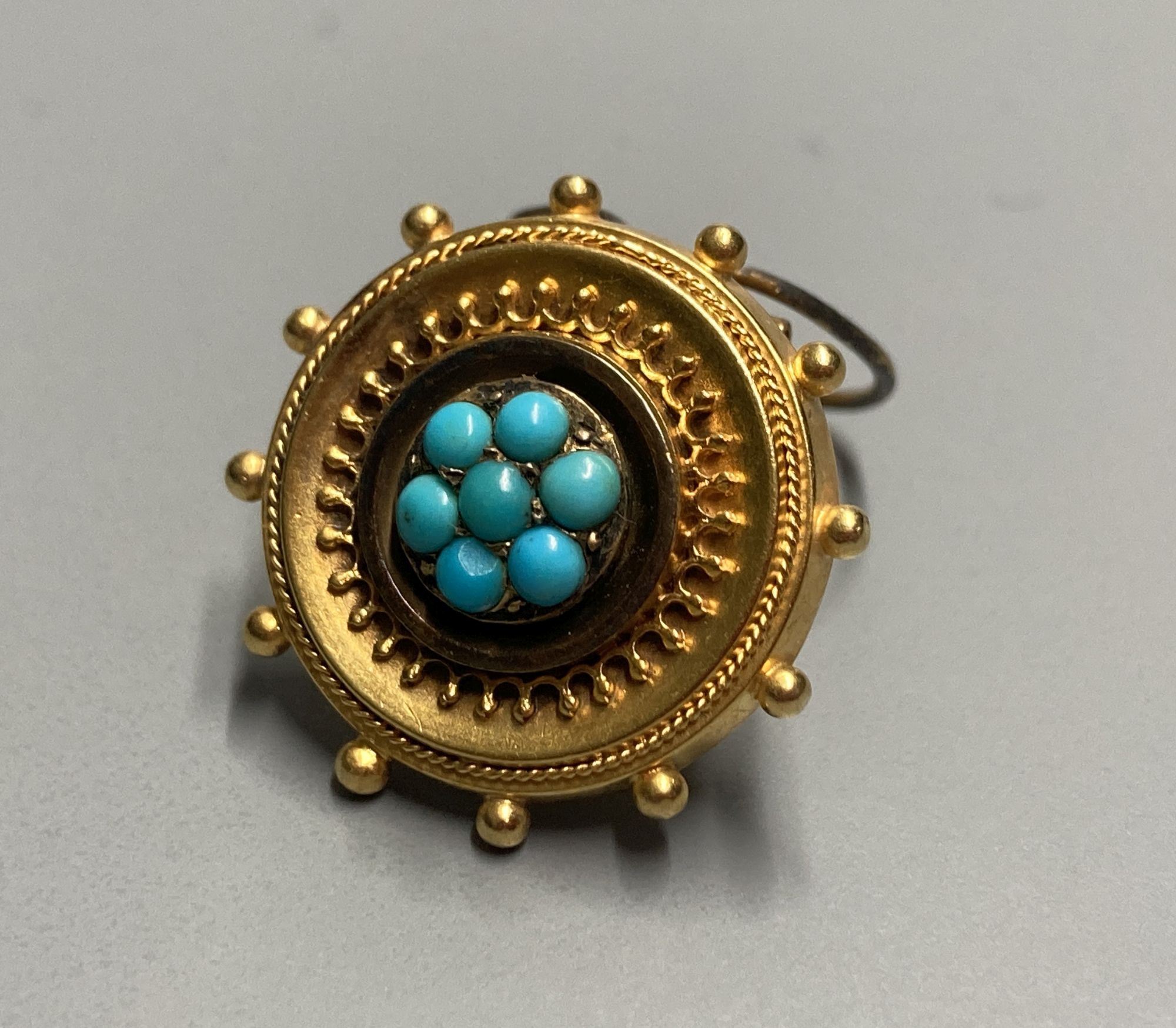 A late Victorian yellow metal and turquoise set circular brooch?? (now with wire for ear clip??), 17mm, gross 2.9 grams.
